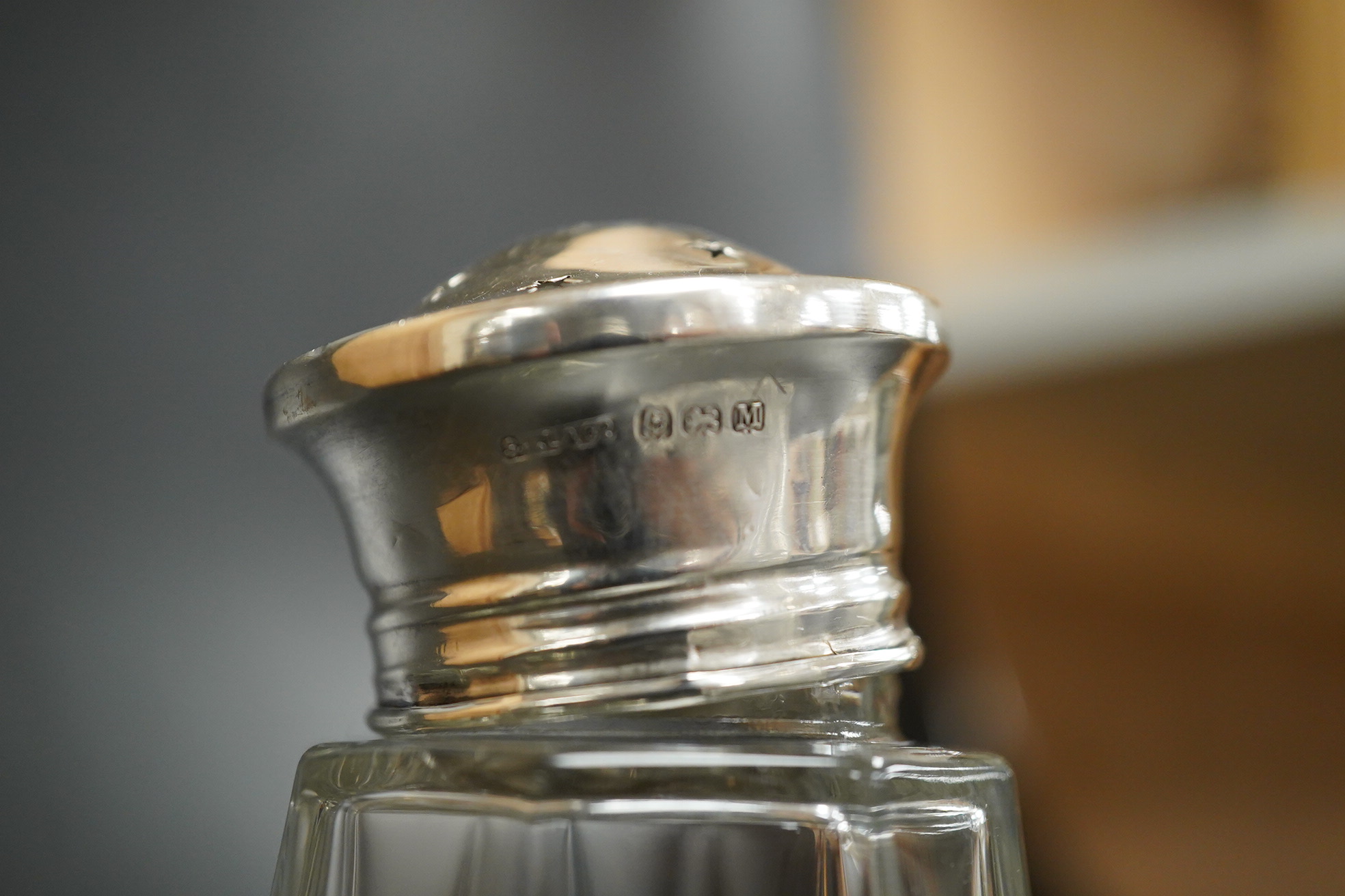 A German 800 standard white metal mounted cut glass decanter and stopper, overall height 36.5cm, together with a George VI silver mounted glass sugar caster.